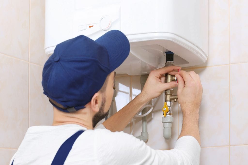 Professional plumber installing Electric Water Heater Installation